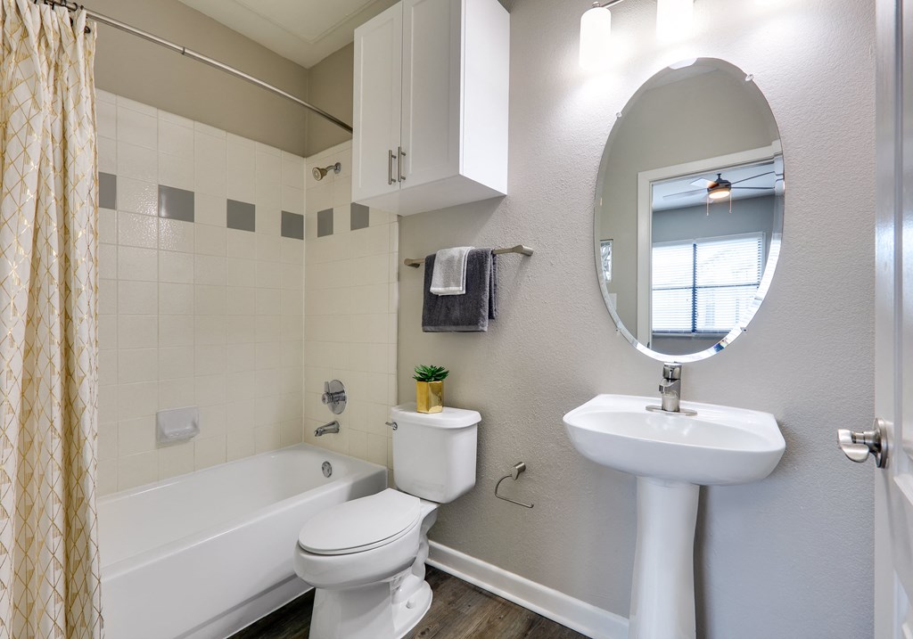 a bathroom with a sink toilet and a bath tub