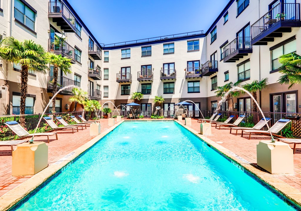 a large swimming pool in front of an apartment building