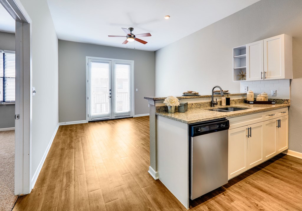 a kitchen with an island and a ceiling fan
