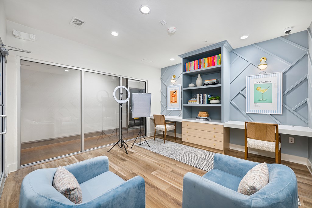 A room with a blue chair and a whiteboard.