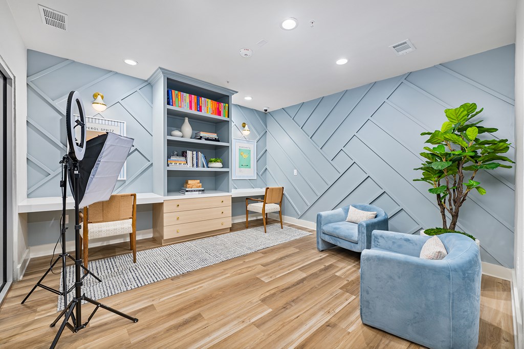 A room with a blue chair and a blue couch.