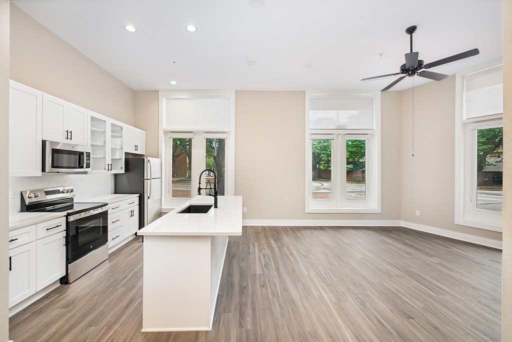 A modern kitchen with a white island in the middle.