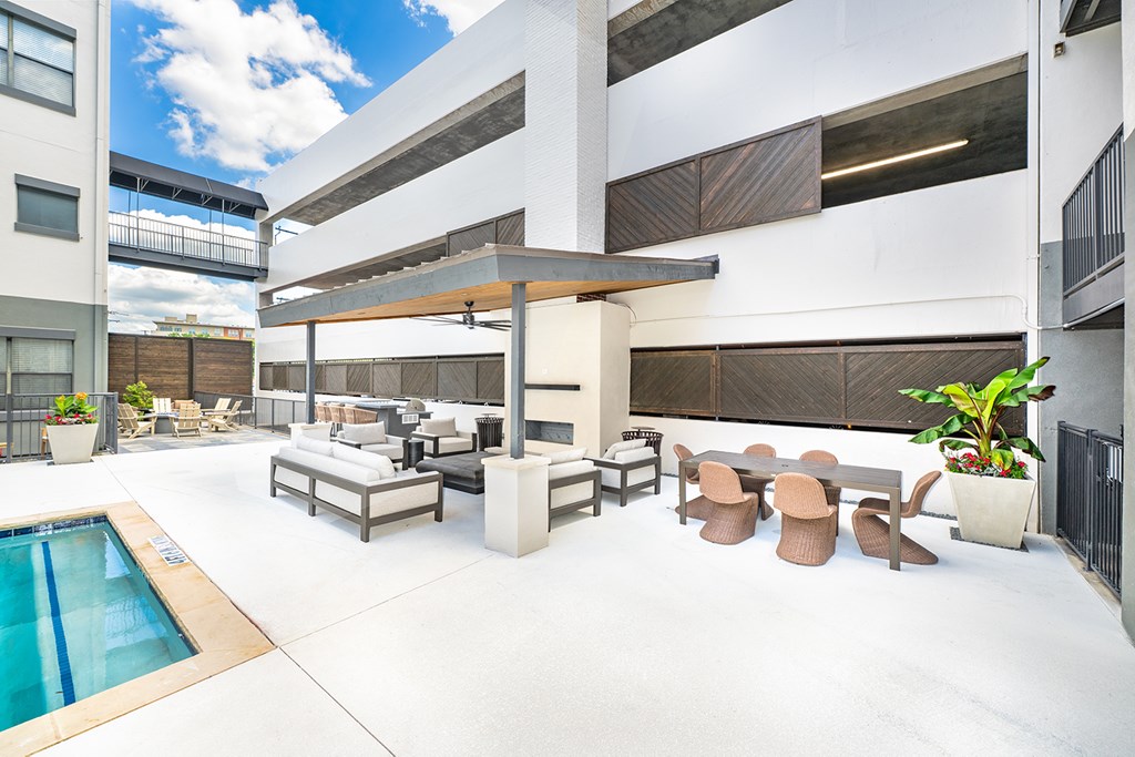 A modern outdoor patio area with a pool.