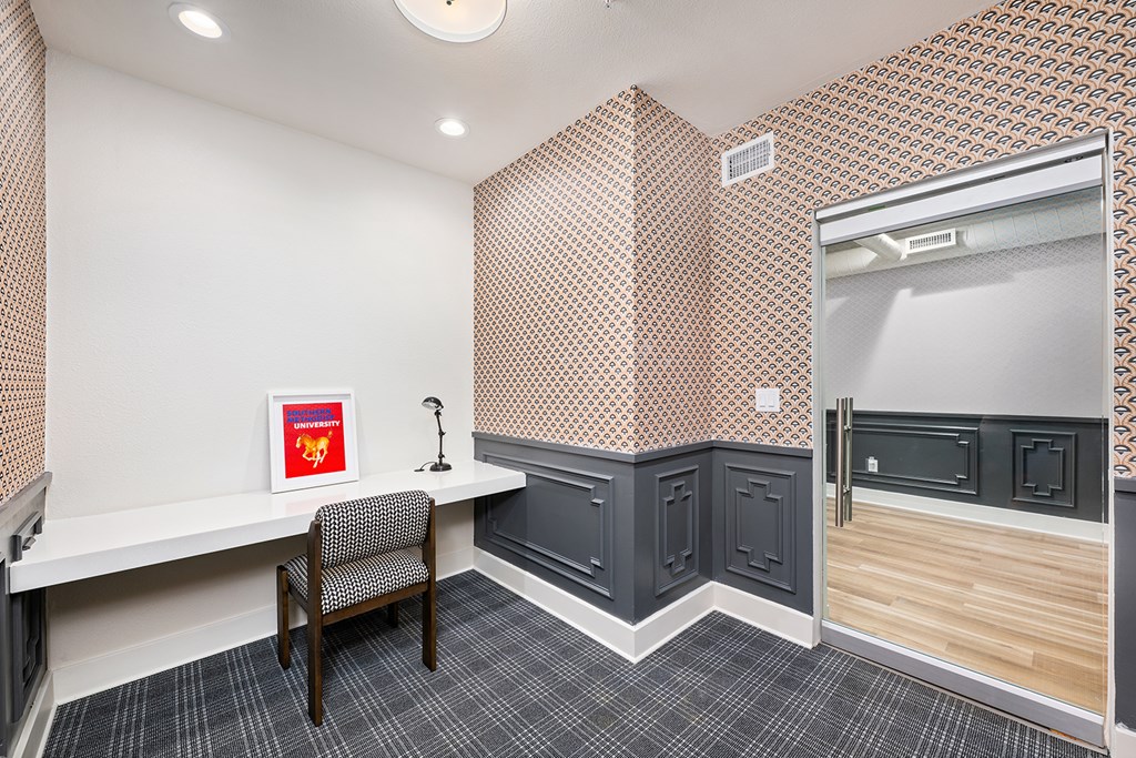 A room with a desk and a chair.