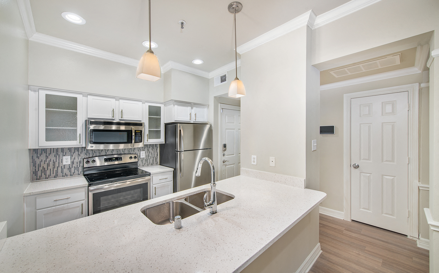 a kitchen with stainless steel appliances and a white counter top