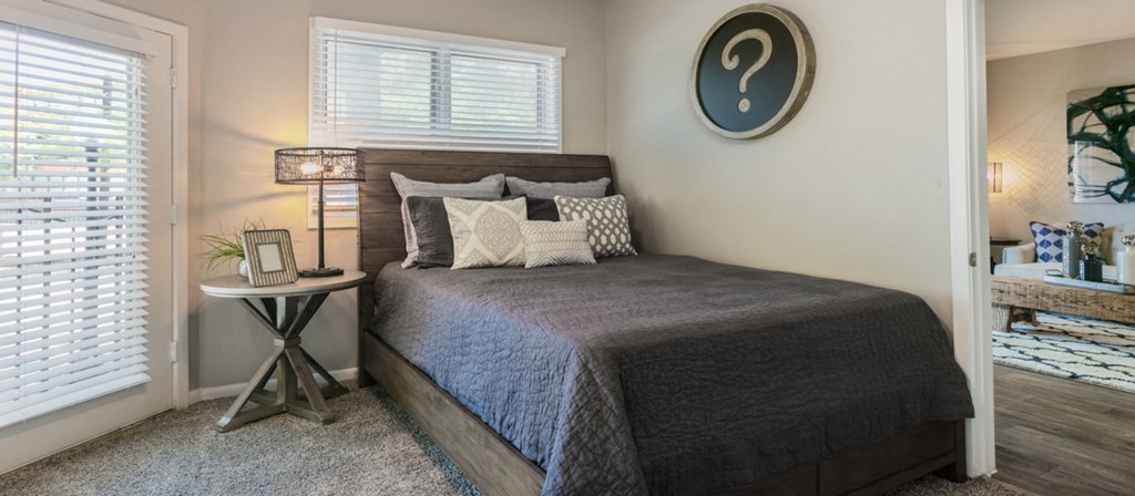 a bedroom with a bed and a window