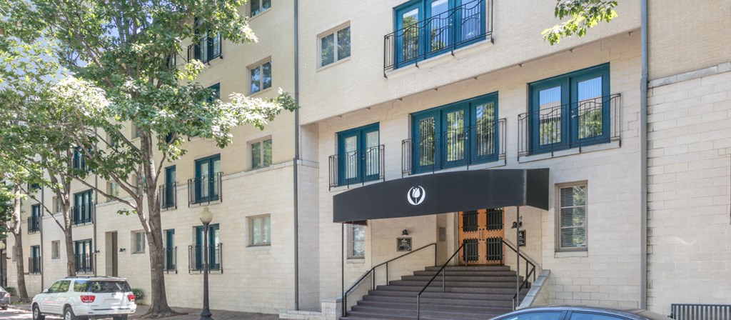 the facade of a building with a black entrance and stairs
