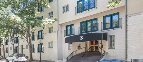 the facade of a building with a black entrance and stairs