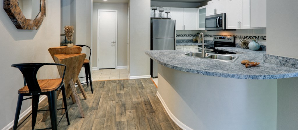 a kitchen with a bar and a counter top in a house