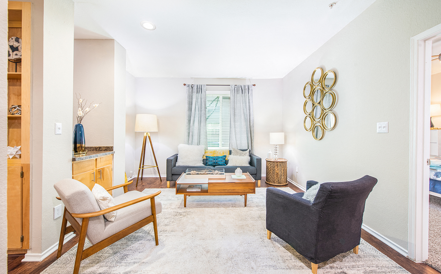 a living room with a couch and chairs and a table