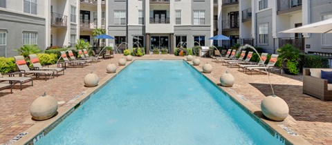 a large swimming pool in front of an apartment building