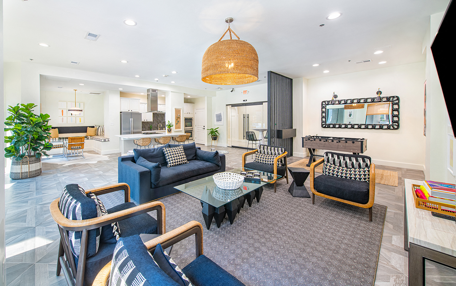 a living room with blue couches and chairs and a table