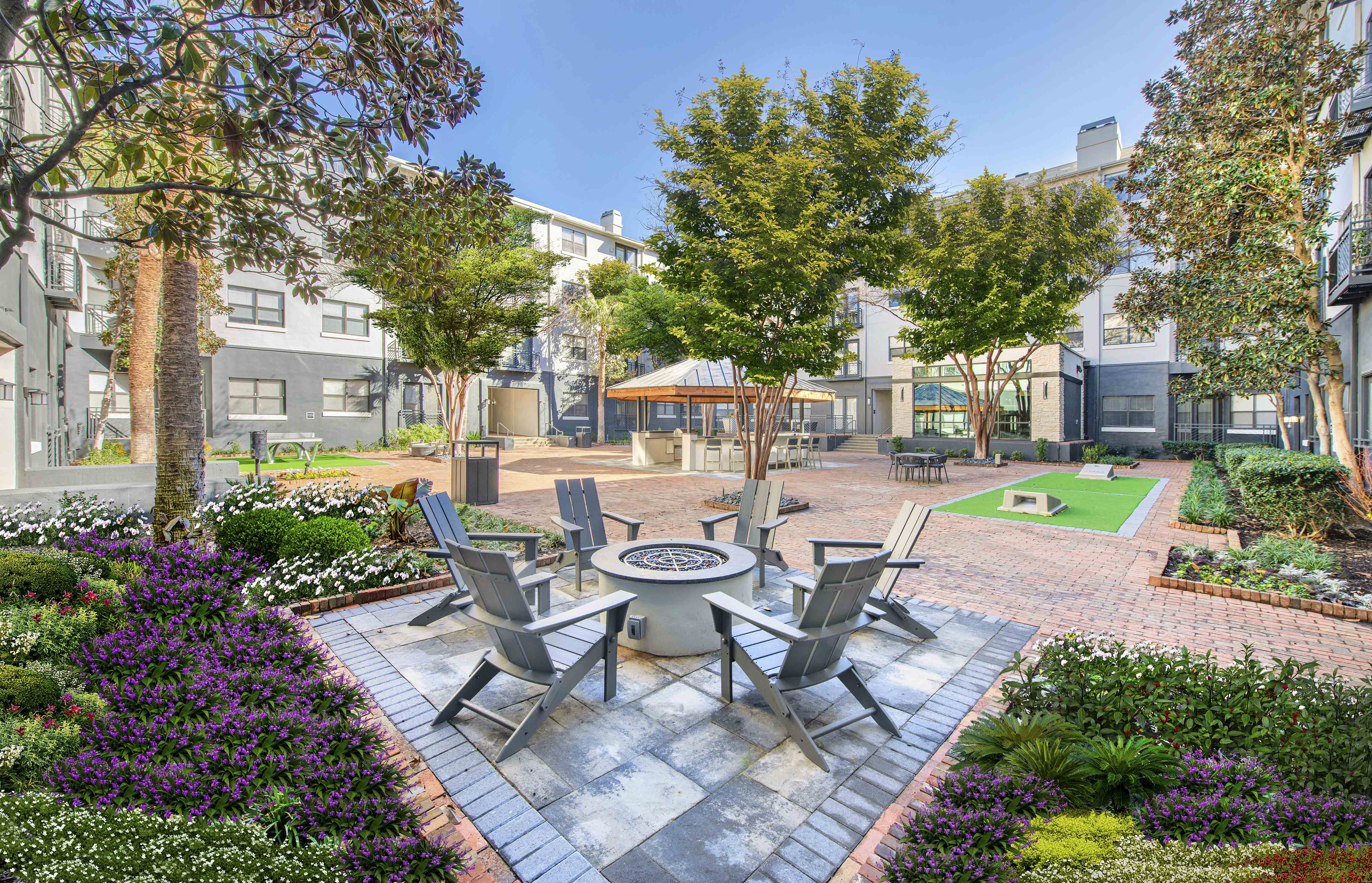 an outdoor courtyard with tables and chairs and trees
