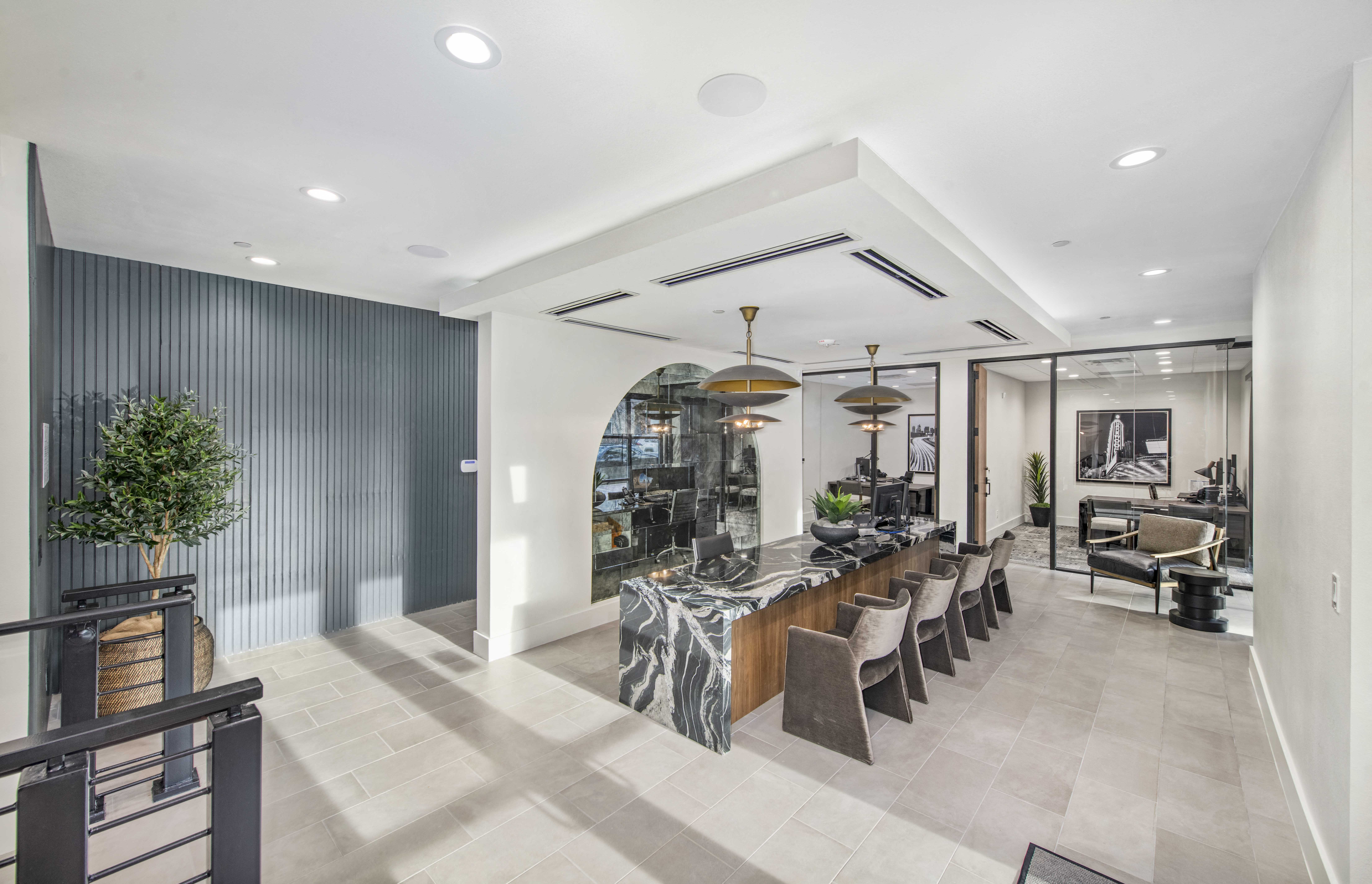 the lobby of a restaurant with a long bar and chairs
