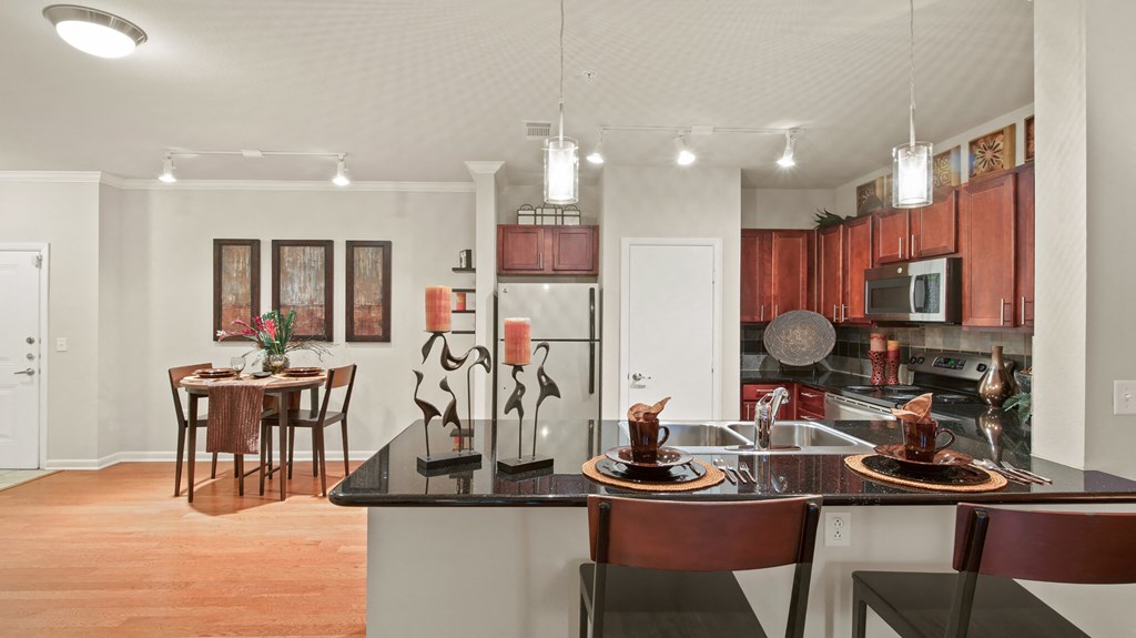 a kitchen with a island and a dining room with a table