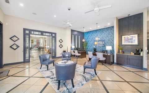 a lobby with a reception area and a table with chairs