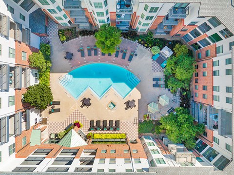 an aerial view of a swimming pool in the middle of an apartment building