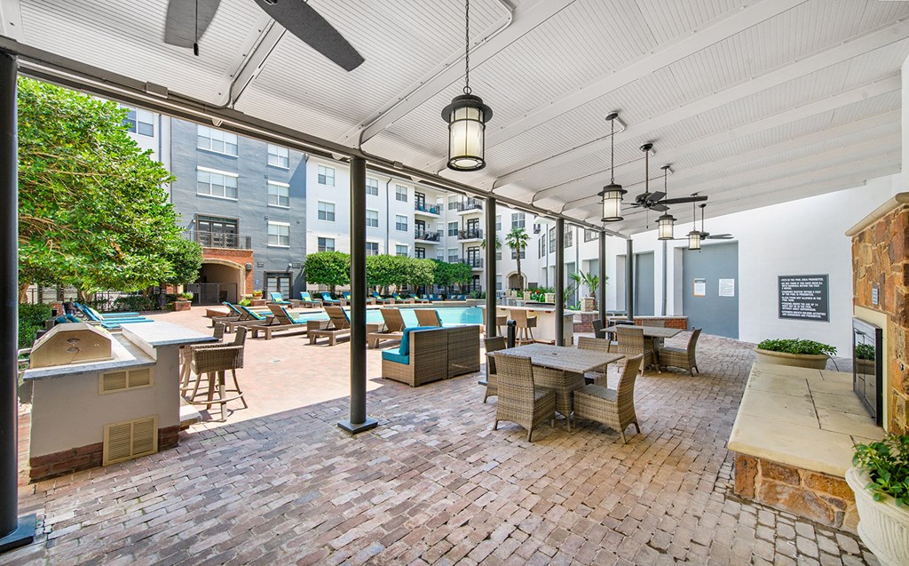 a large patio with tables and chairs and a pool