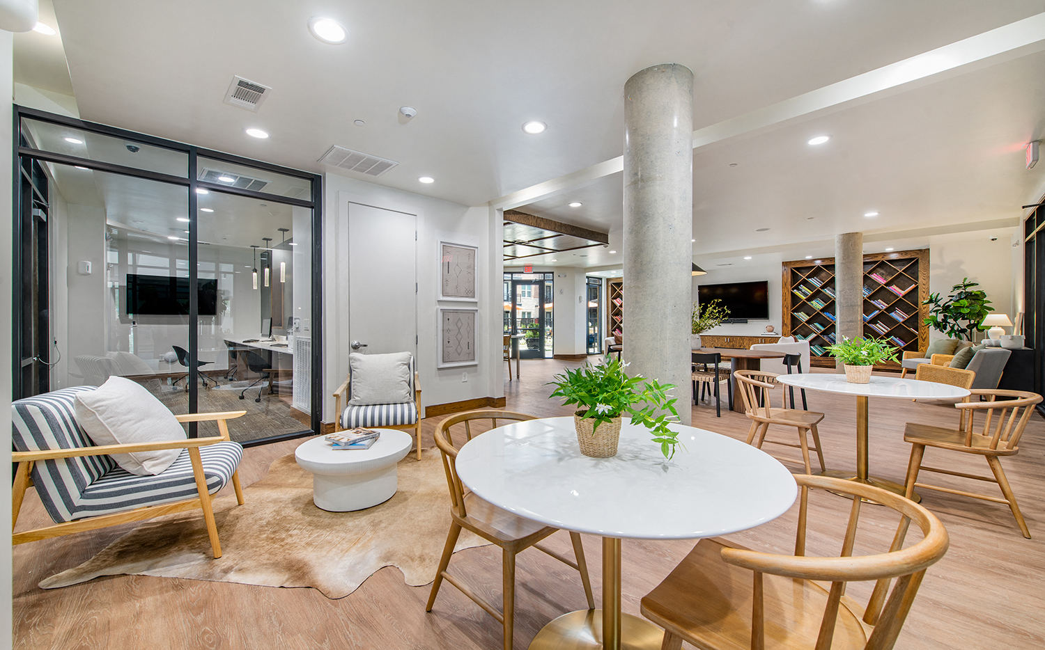 a large living room with tables and chairs