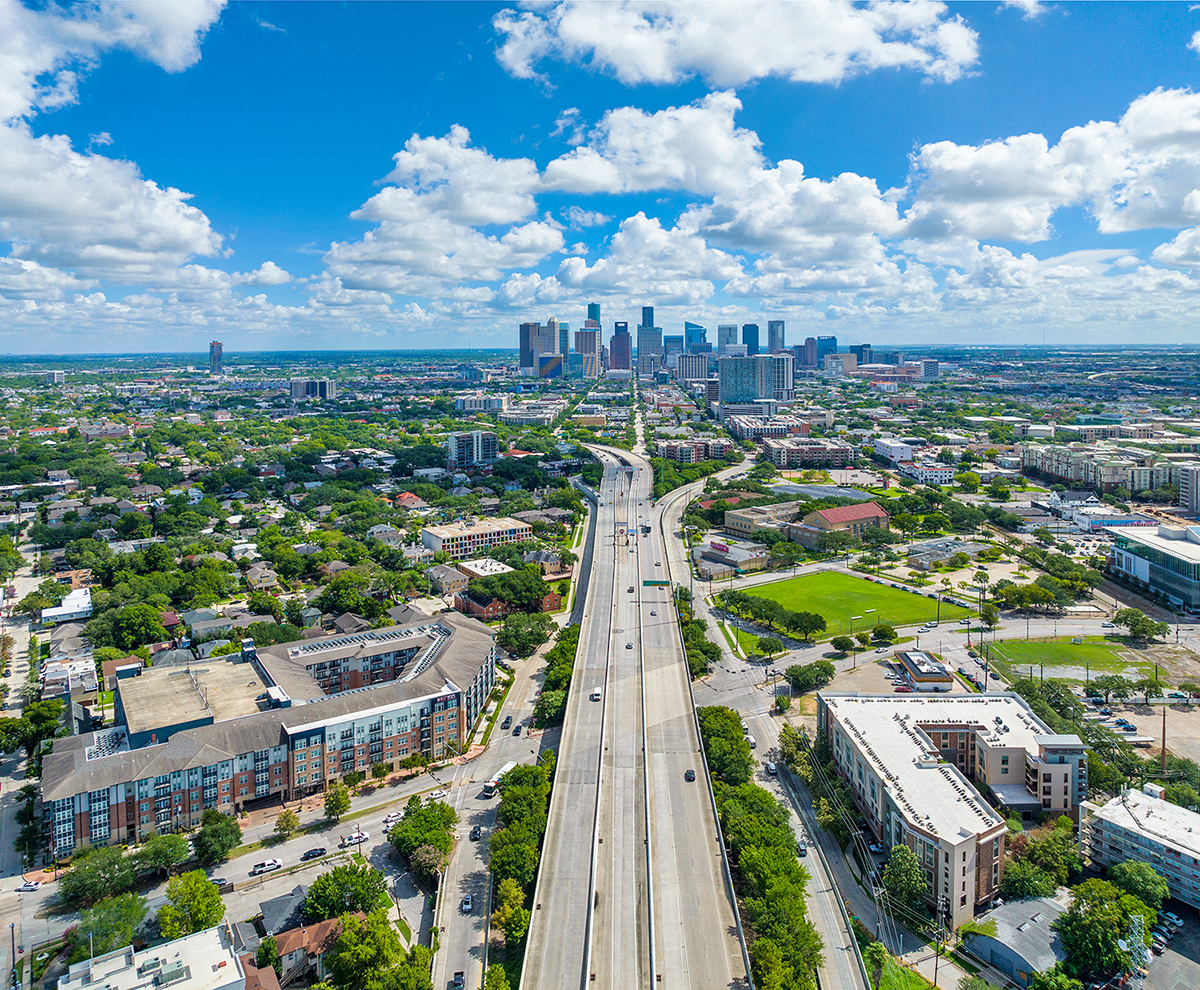 an aerial view of the city with highways and buildings