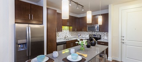 a kitchen with stainless steel appliances and a granite counter top