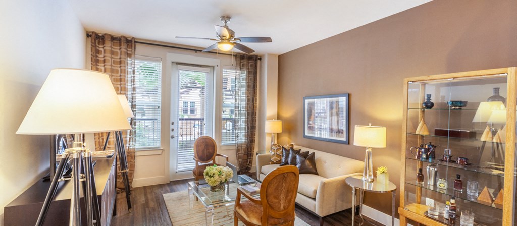 a living room with a couch and a ceiling fan