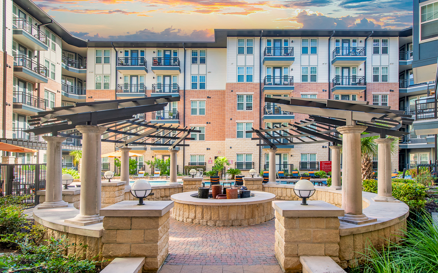 a courtyard with a fountain and an apartment building