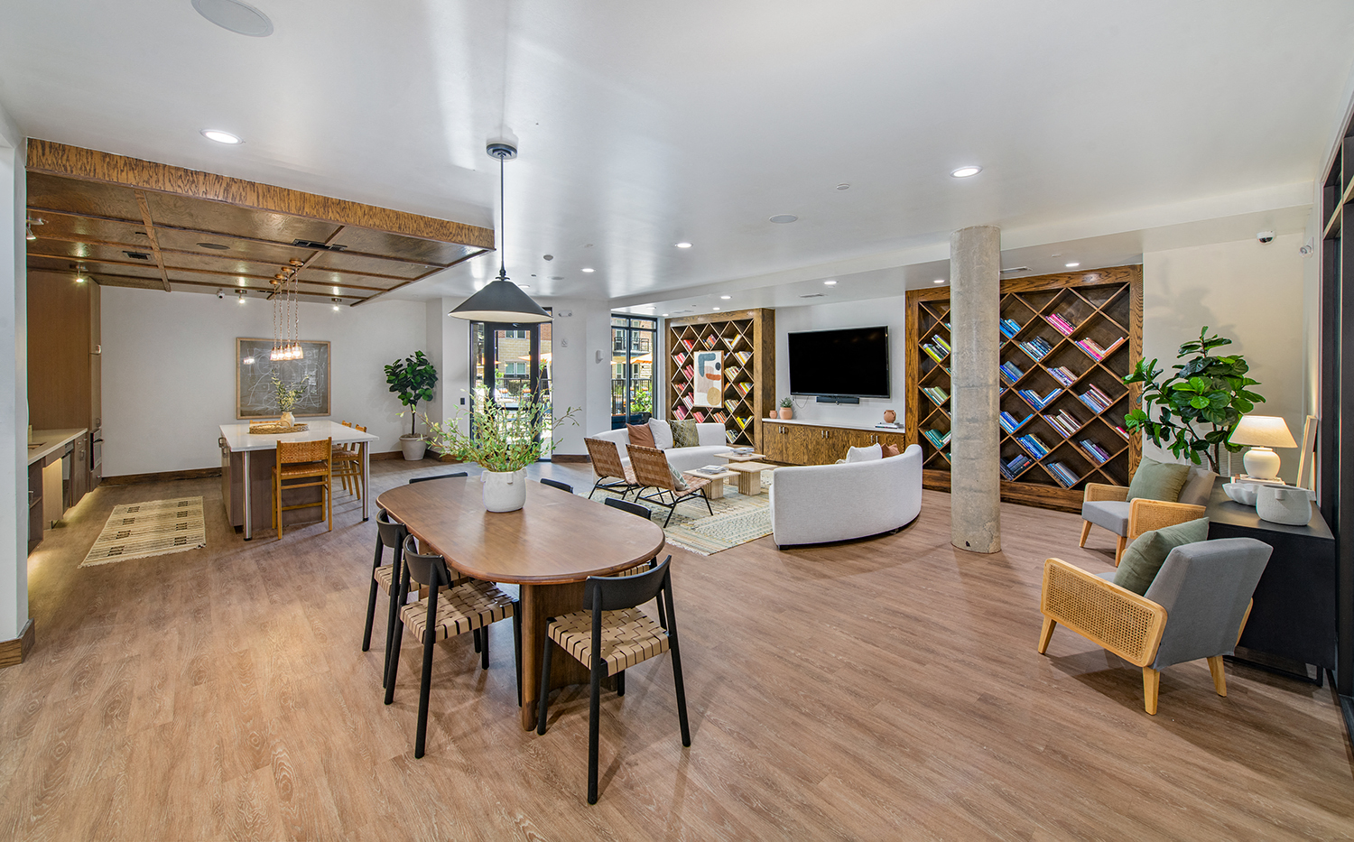 a living room and dining room with a table and chairs