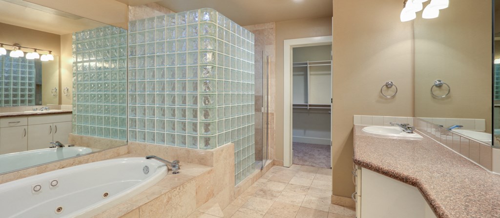 a bathroom with a tub and a shower and a sink