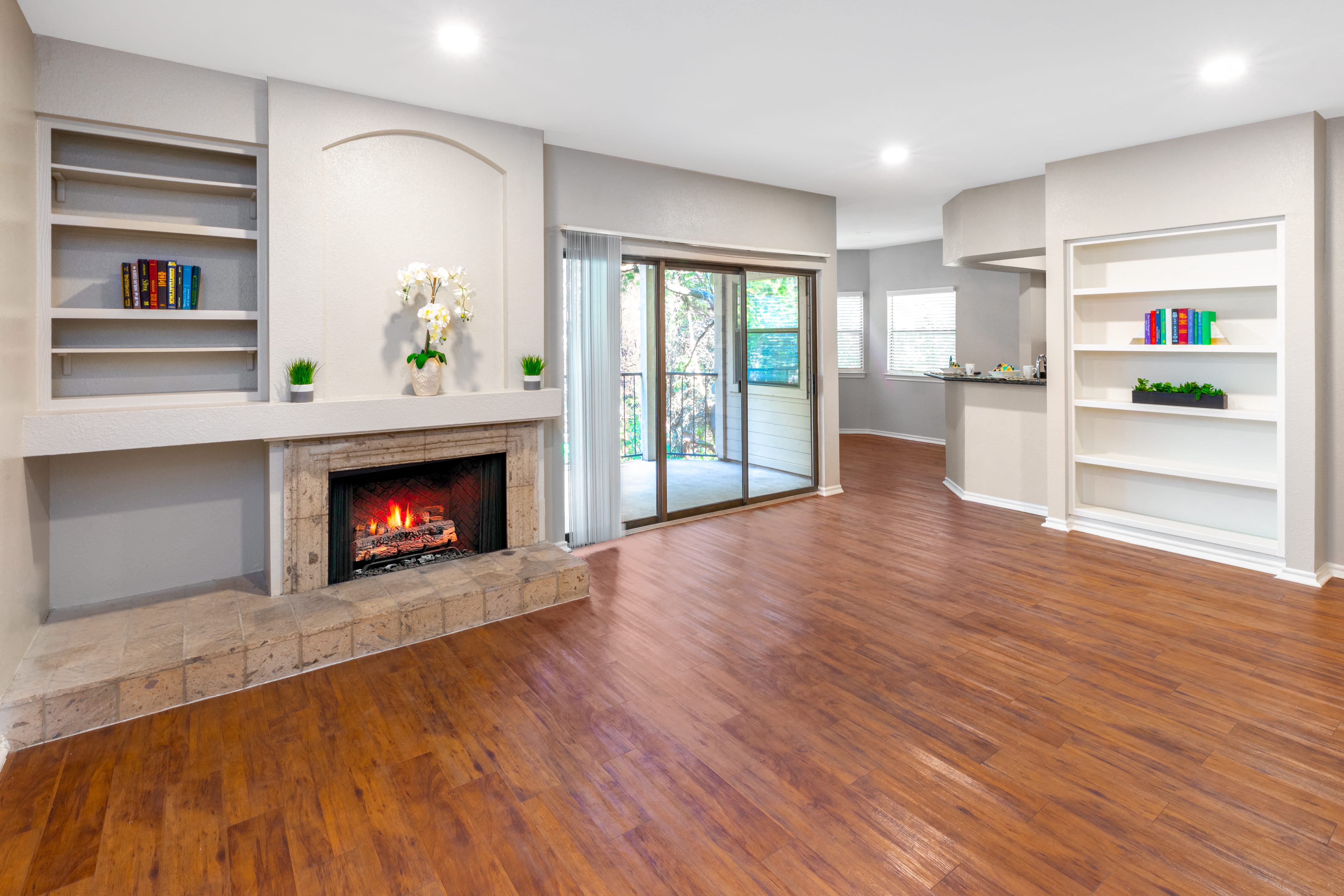 a living room with a fireplace and a wooden floor
