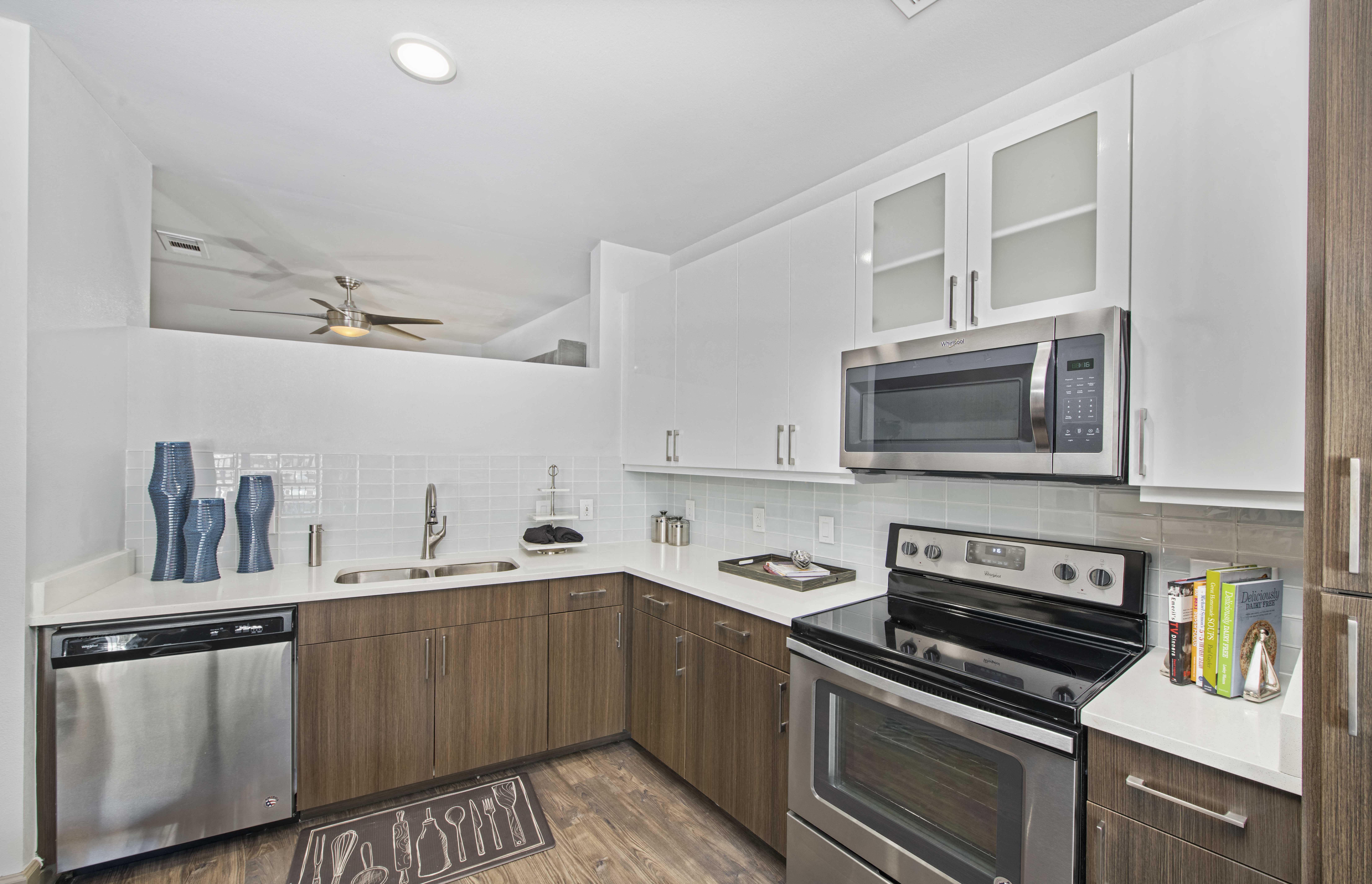 a kitchen with stainless steel appliances and white cabinets