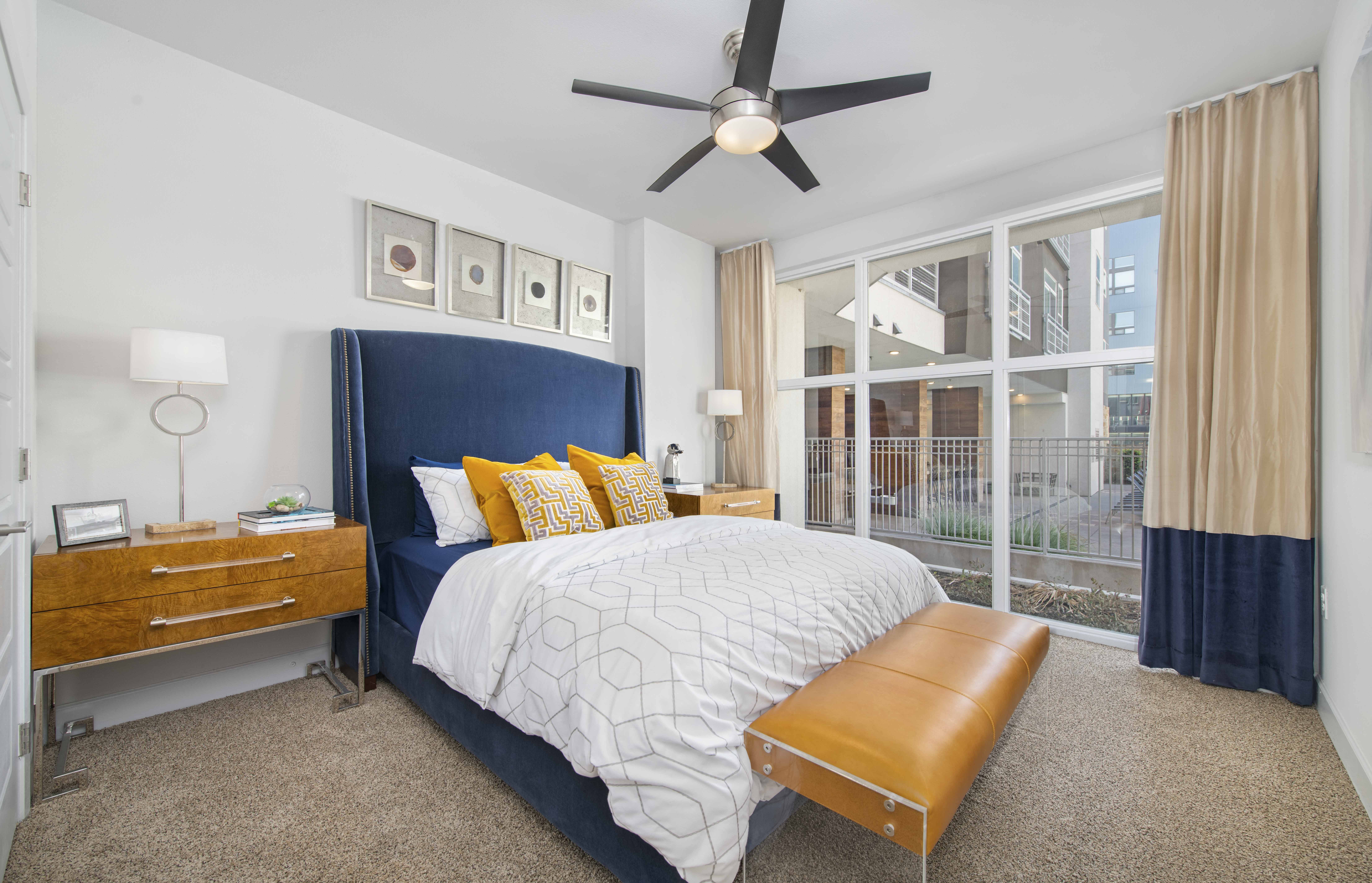 a bedroom with a large bed and a ceiling fan