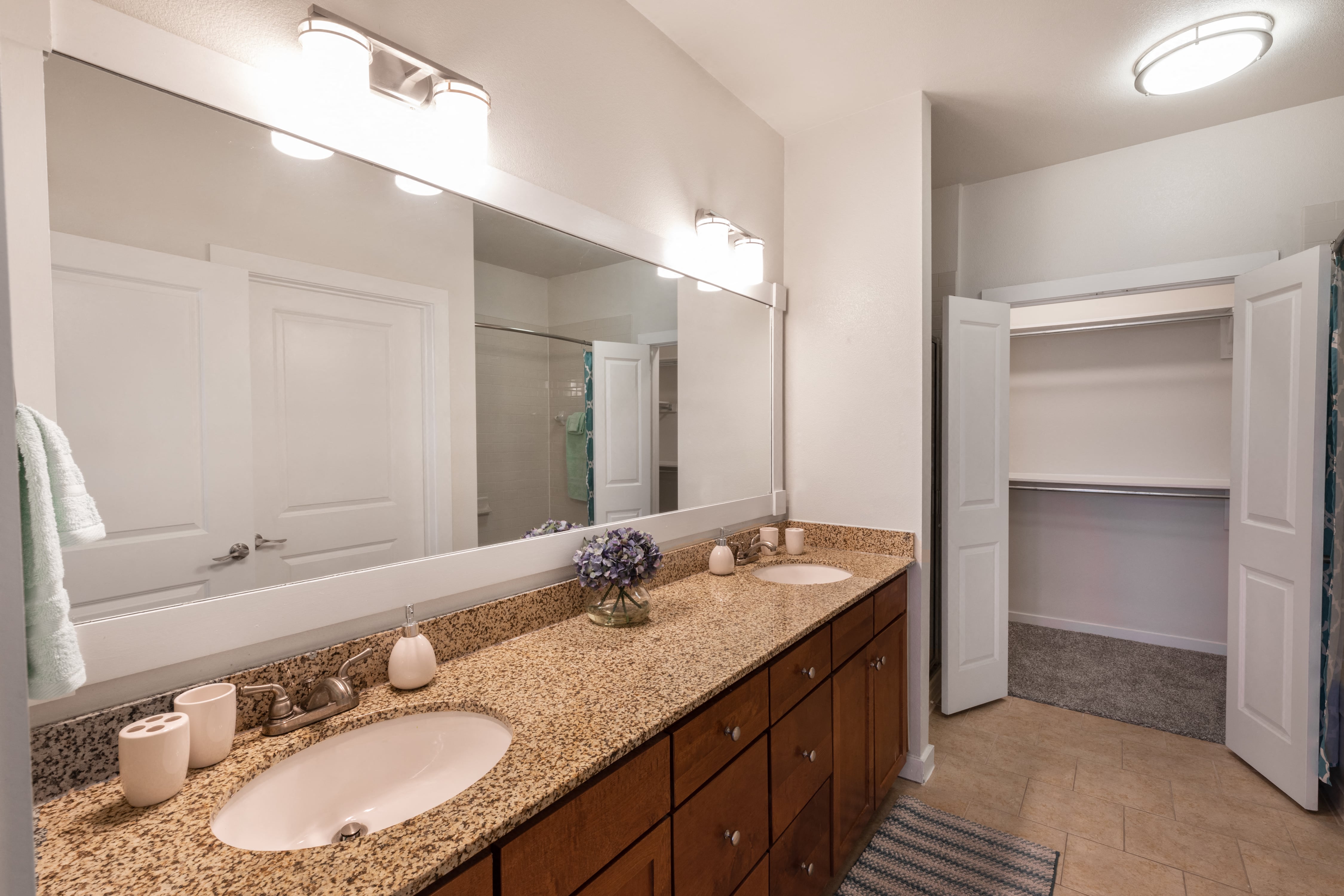 a bathroom with two sinks and a large mirror