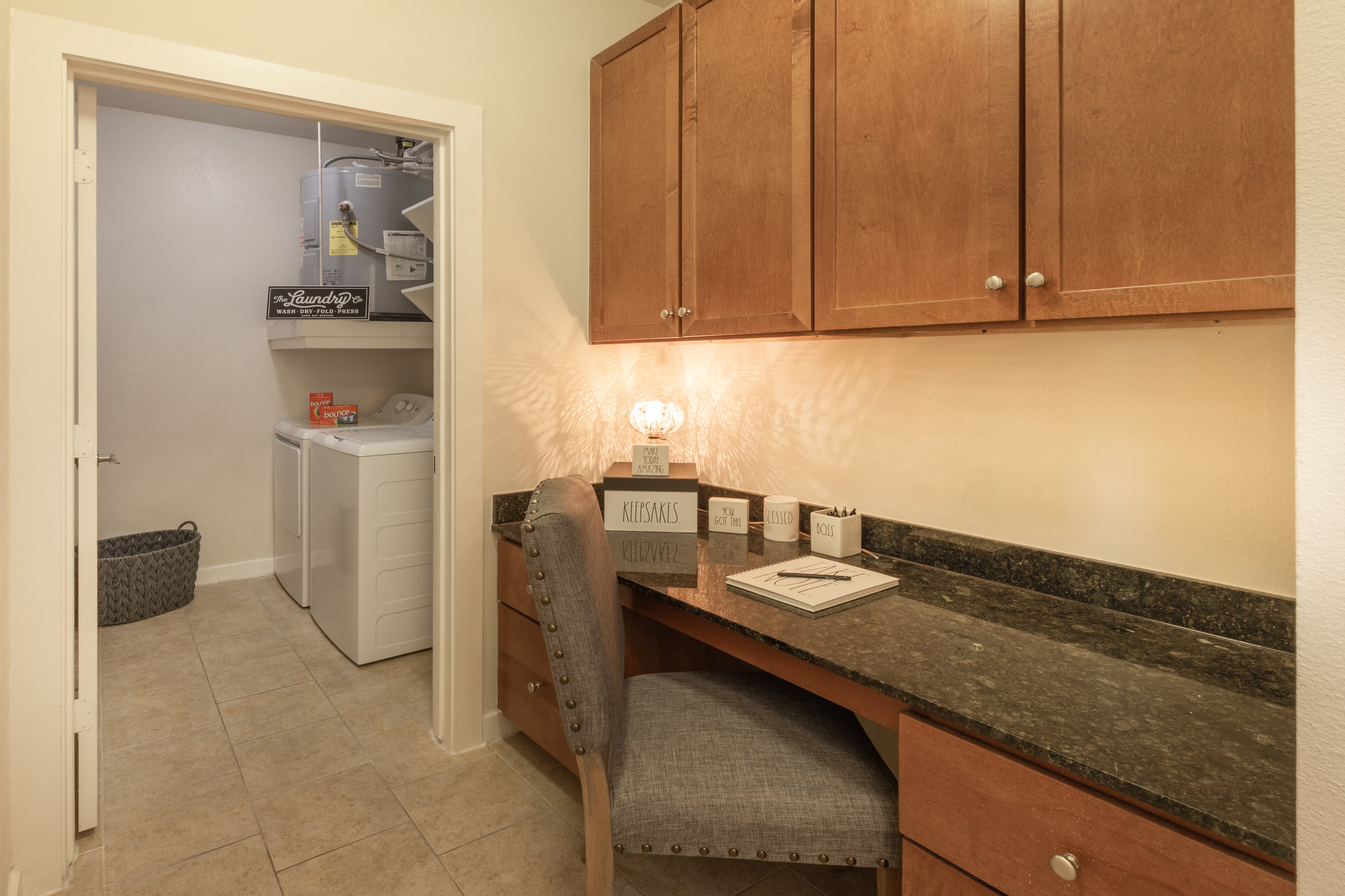 a desk with a chair in a kitchen with a refrigerator