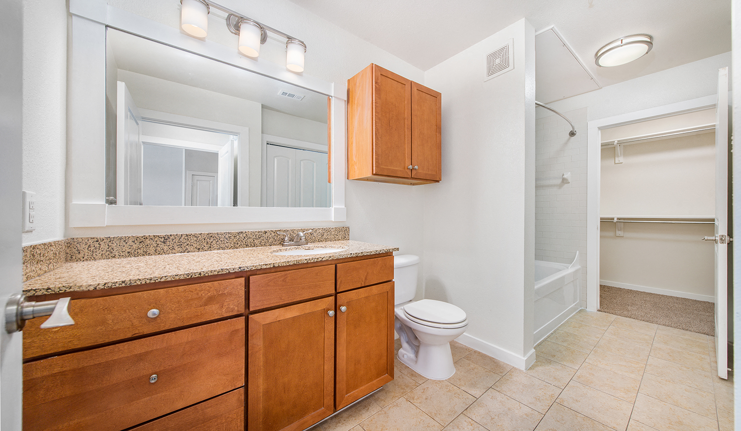 a bathroom with a toilet and a sink and a mirror