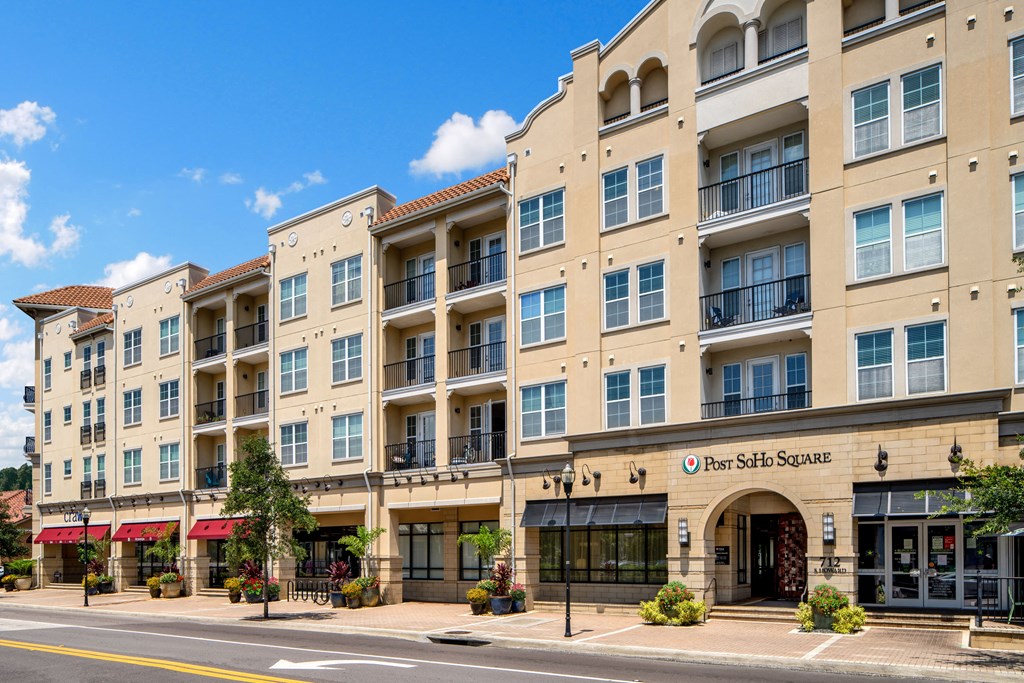 a large apartment building on the corner of a street