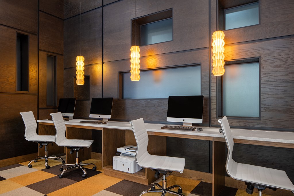 a conference room with four computer desks and chairs