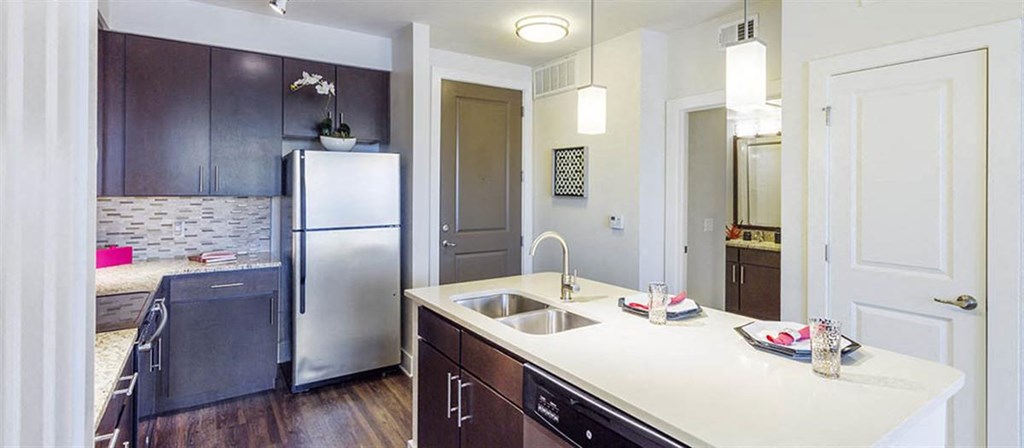 a kitchen with a sink and a refrigerator