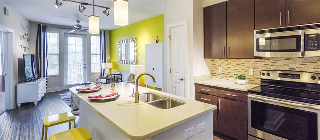 a kitchen with a sink and a stove and a microwave