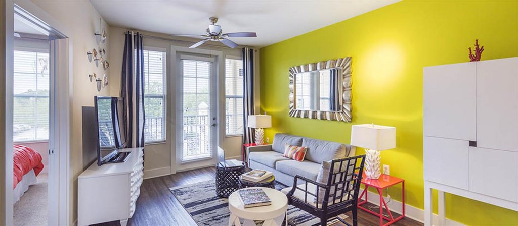 a living room with a yellow wall and a window