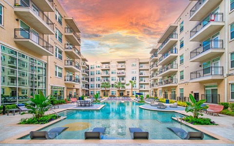 a large swimming pool in the middle of an apartment building