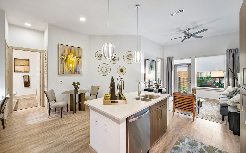 a living room with a kitchen and a dining room
