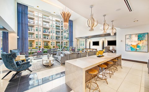 a living room with a kitchen and a large window