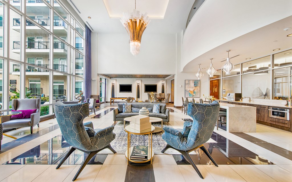 a living room filled with furniture and large windows