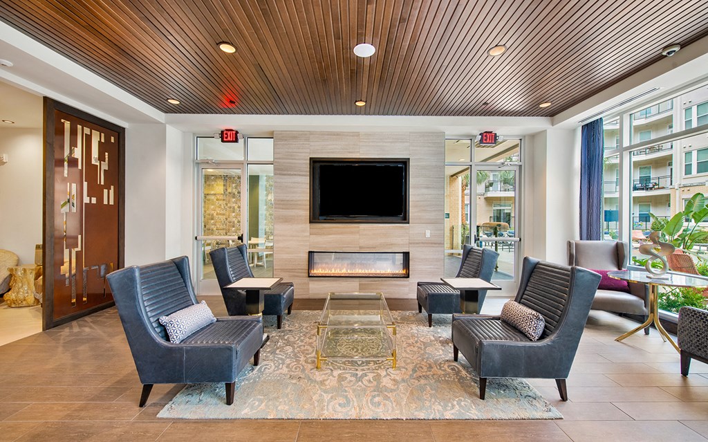 a lobby with a fireplace and a television