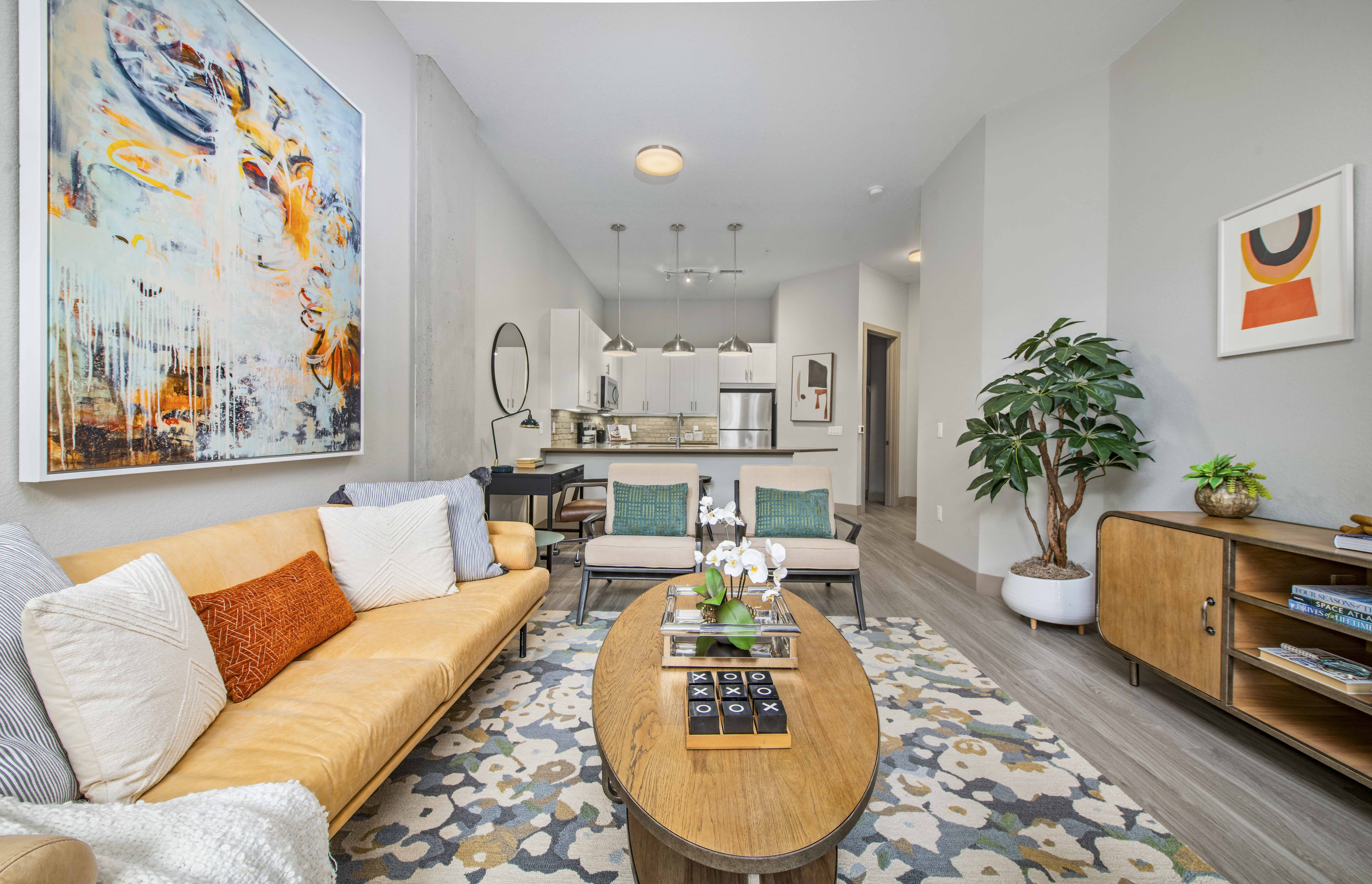a living room with a yellow couch and a coffee table