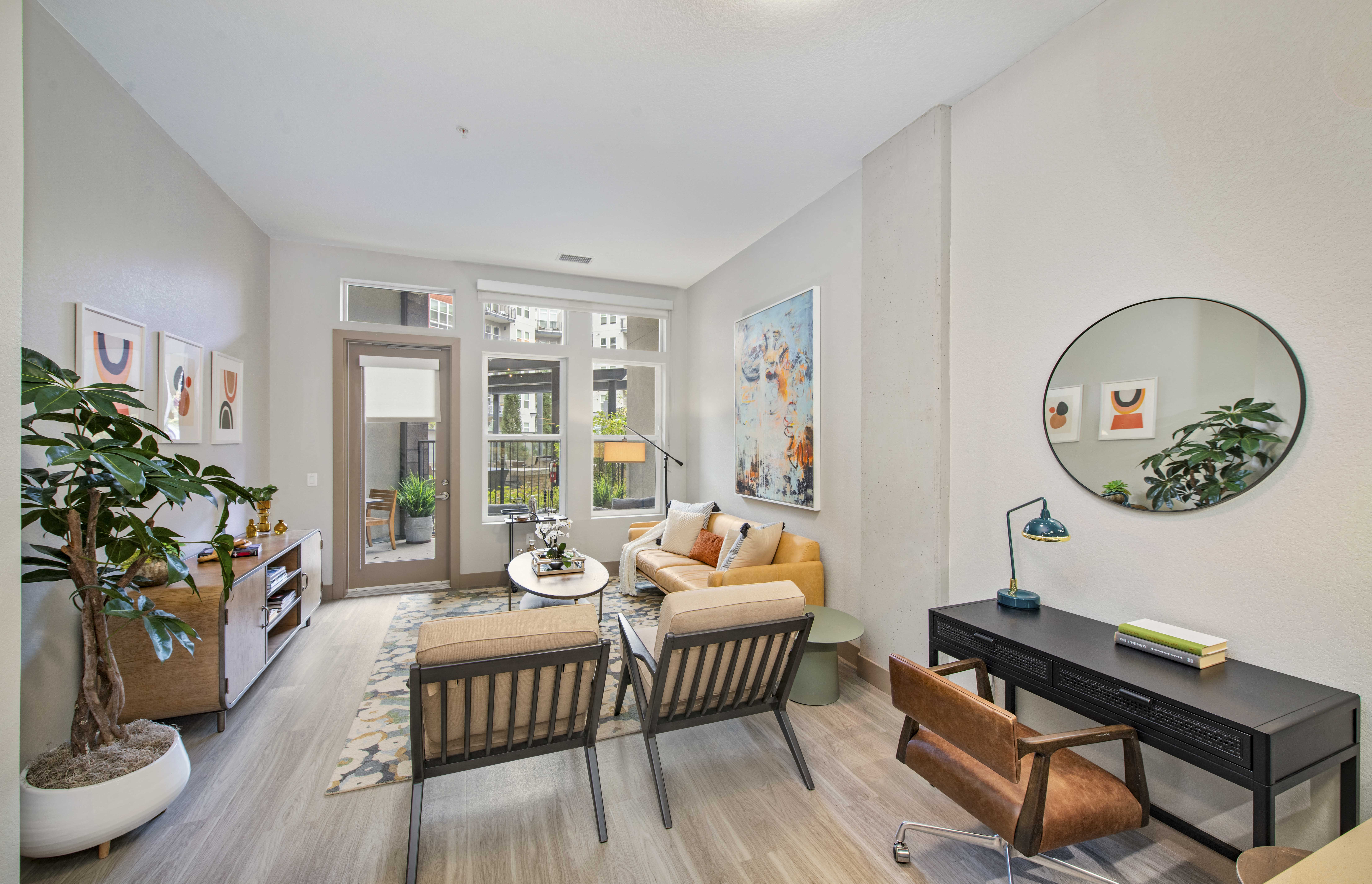 a living room with a couch and chairs and a table