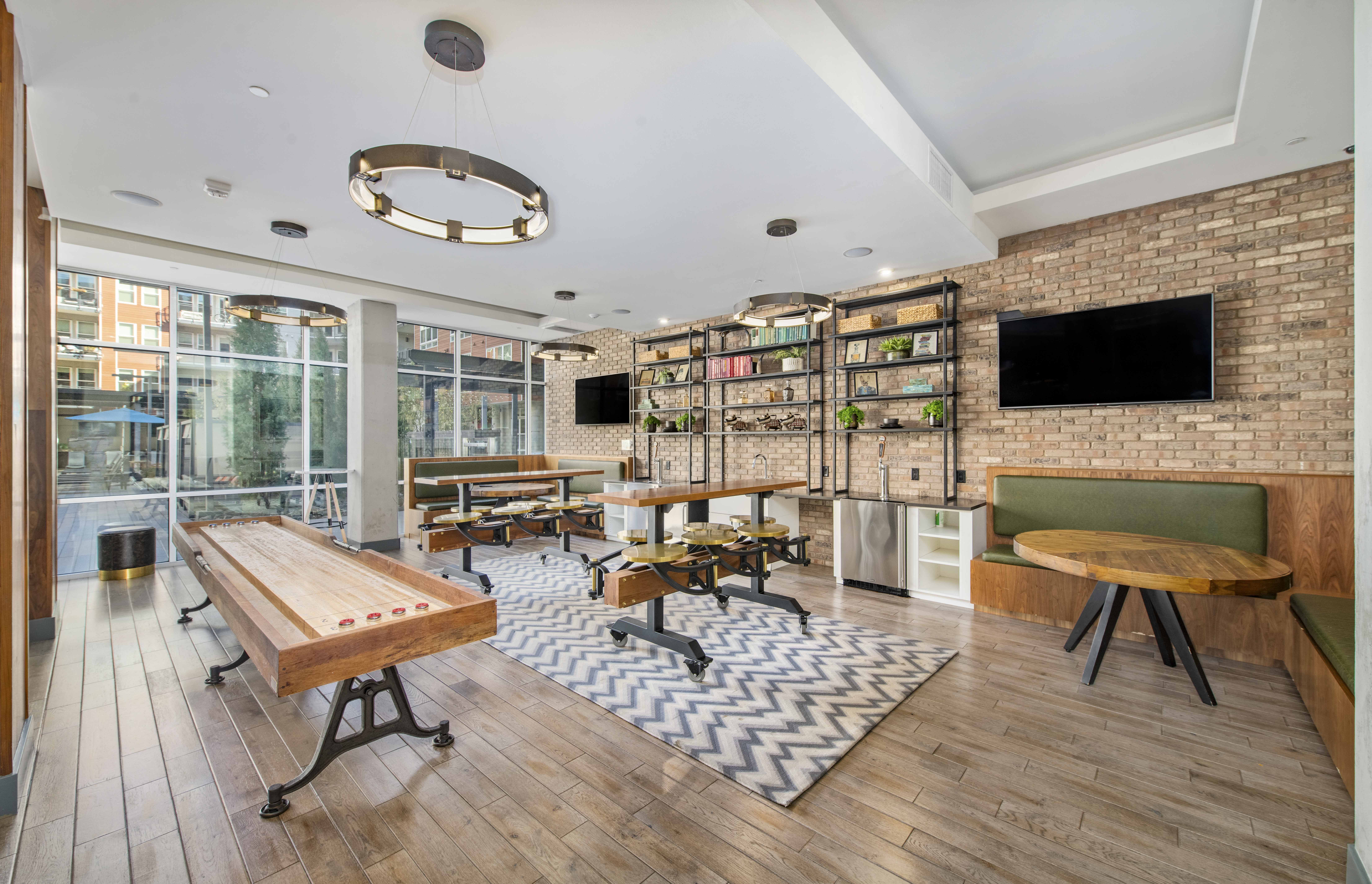a game room with tables and a tv