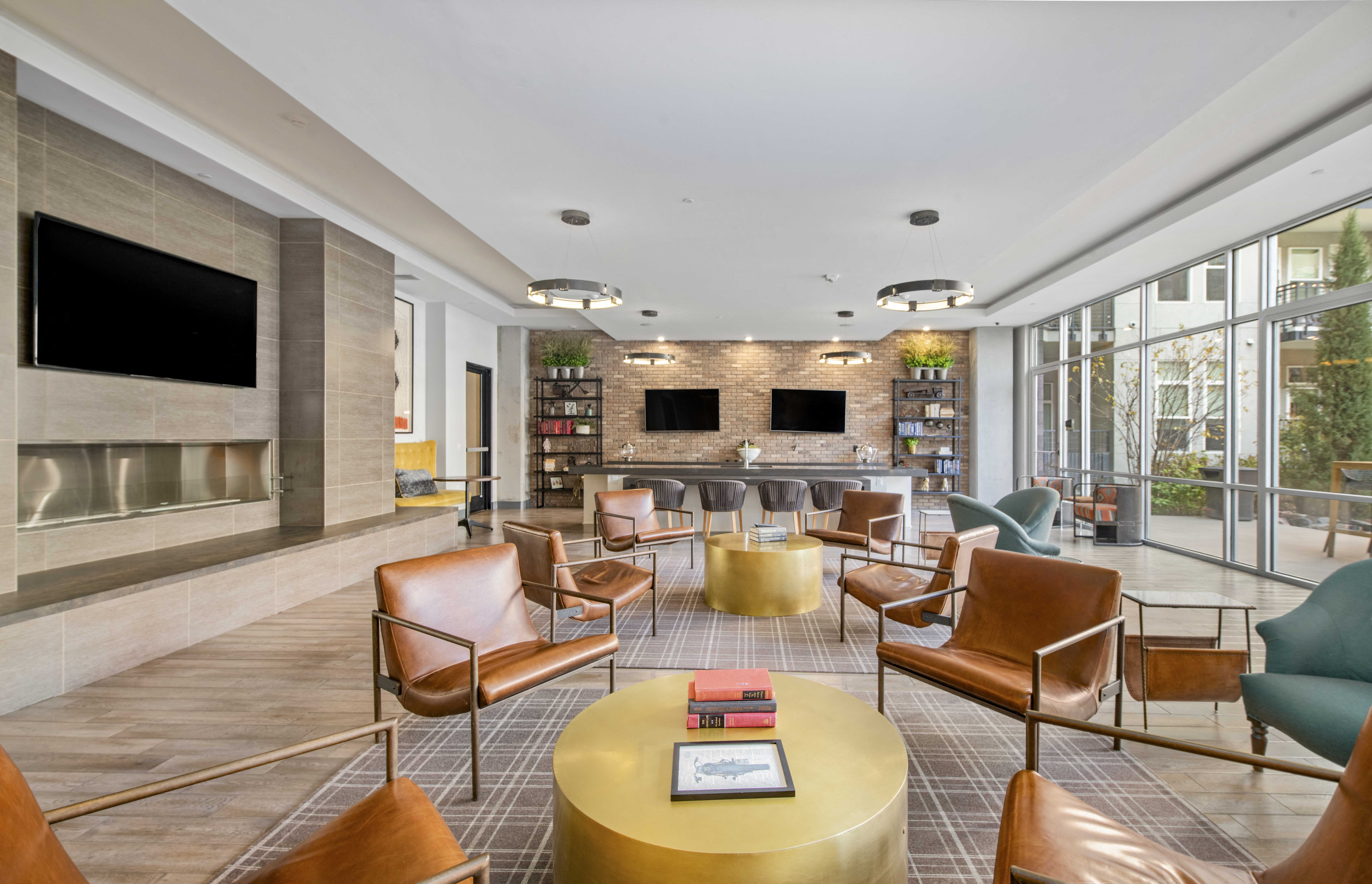 a lobby with chairs and a table and a television
