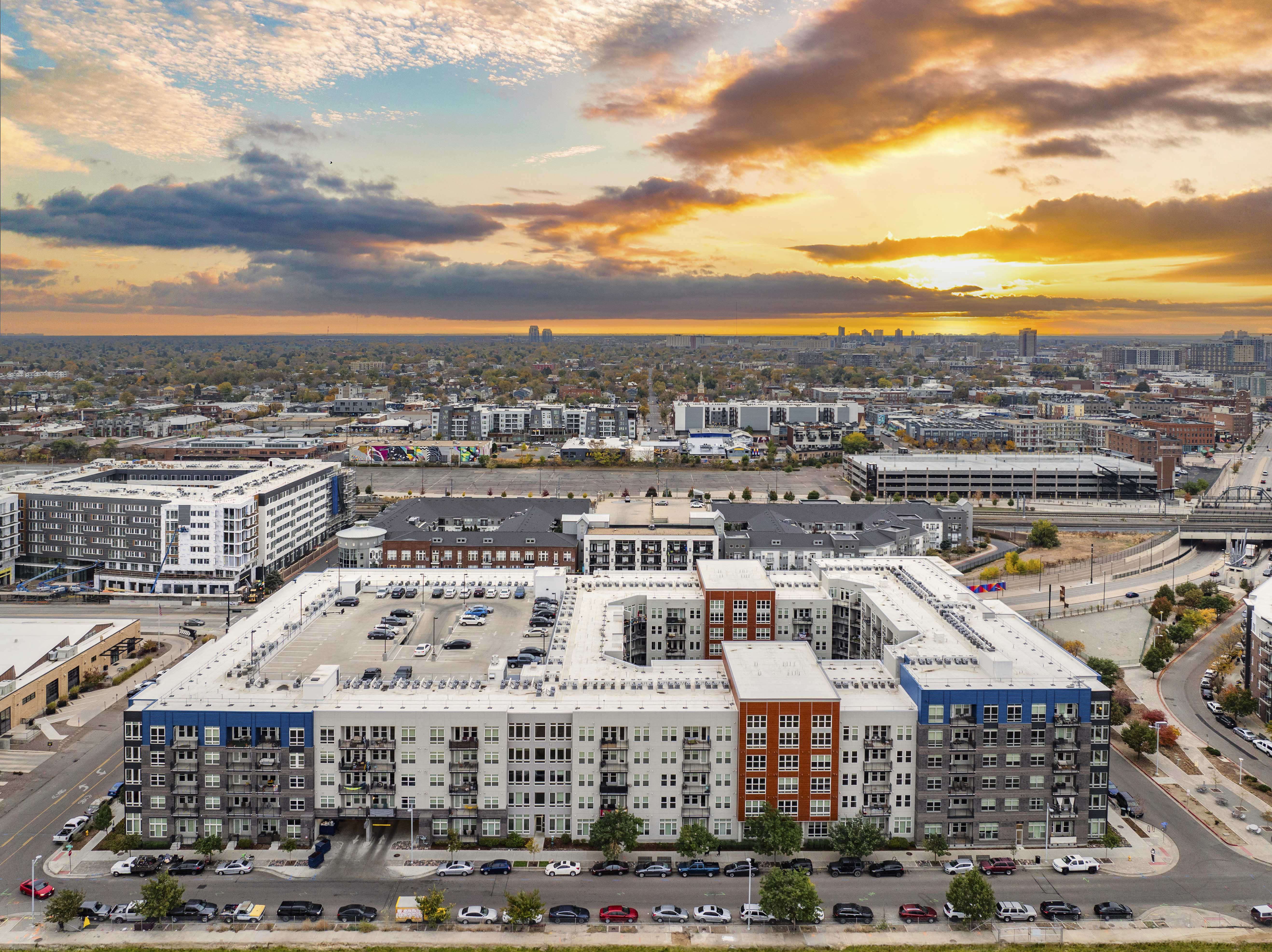 an aerial view of a city with a building and a parking lot